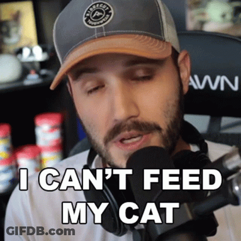 A Man Wearing A Hat And Headphones Says I Can T Feed My Cat GIF