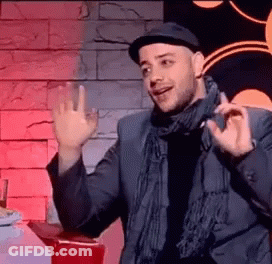 A Man Wearing A Hat And Scarf Is Giving A Thumbs Up Sign . GIF
