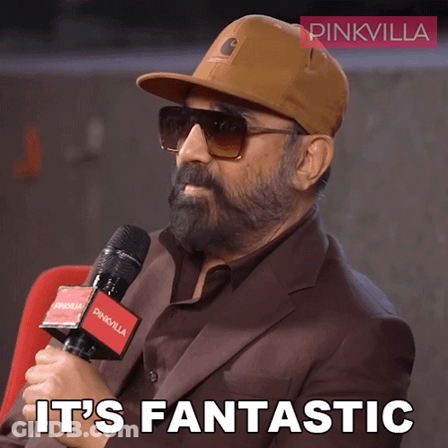 A Man Wearing A Hat And Sunglasses Holds A Microphone And Says " It 'S Fantastic " GIF