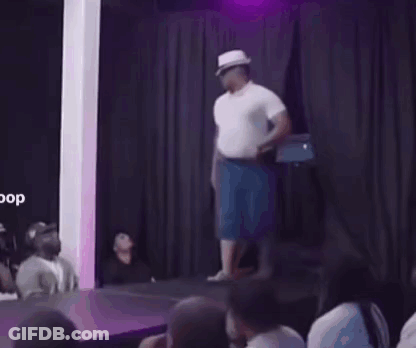 A Man Wearing A Hat And Sunglasses Is Dancing In A Room . GIF