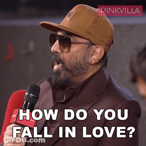 A Man Wearing A Hat And Sunglasses Is Holding A Microphone And Asking How Do You Fall In Love GIF