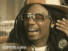 A Man Wearing A Hat And Sunglasses Is Smiling GIF