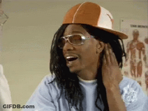 A Man Wearing A Hat And Sunglasses Is Smiling While Touching His Ear . GIF