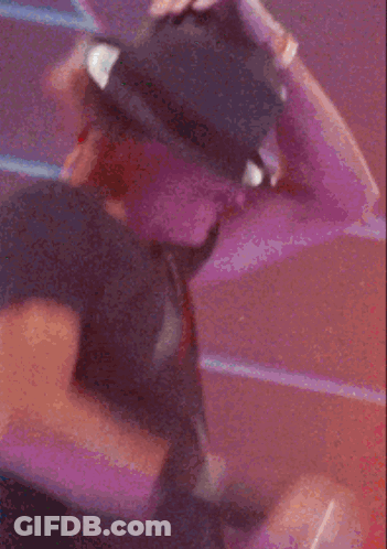 A Man Wearing A Hat And Sunglasses Is Standing In Front Of A Staircase GIF