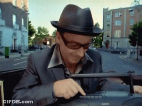 A Man Wearing A Hat And Sunglasses Is Using A Keyboard GIF