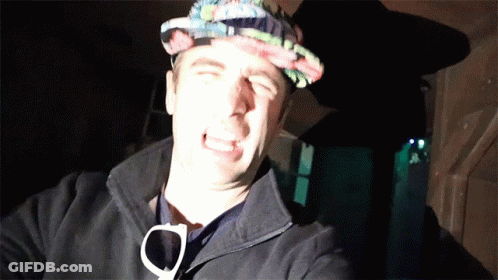 A Man Wearing A Hat And Sunglasses Making A Face GIF