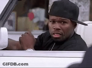 A Man Wearing A Hat Is Driving A Car And Making A Funny Face . GIF