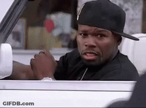 A Man Wearing A Hat Is Driving A Car And Making A Funny Face . GIF