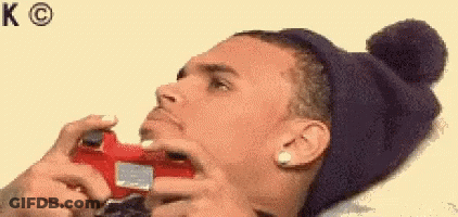 A Man Wearing A Hat Is Playing A Video Game . GIF