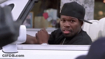 A Man Wearing A Hat Is Sitting In A Car And Looking Out The Window . GIF