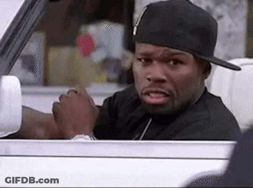 A Man Wearing A Hat Is Sitting In A Car And Looking Out The Window . GIF
