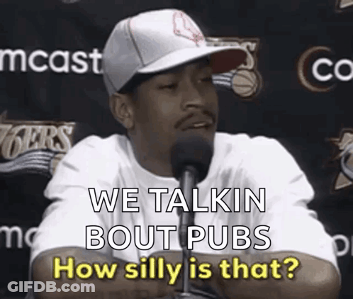 A Man Wearing A Hat Is Talking Into A Microphone And Says We Talkin Bout Pubs How Silly Is That . GIF