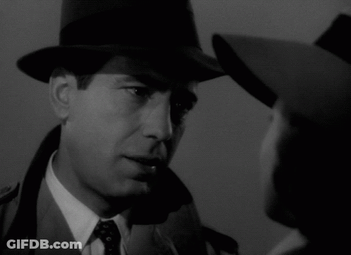 A Man Wearing A Hat Looks At A Woman Wearing A Hat GIF