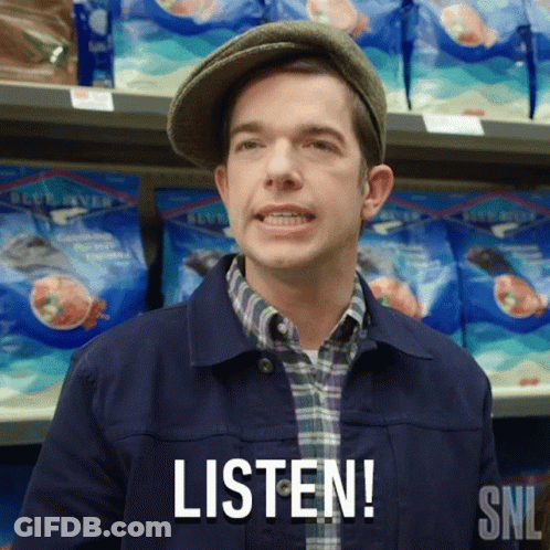 A Man Wearing A Hat Says Listen In Front Of A Shelf Of Food GIF