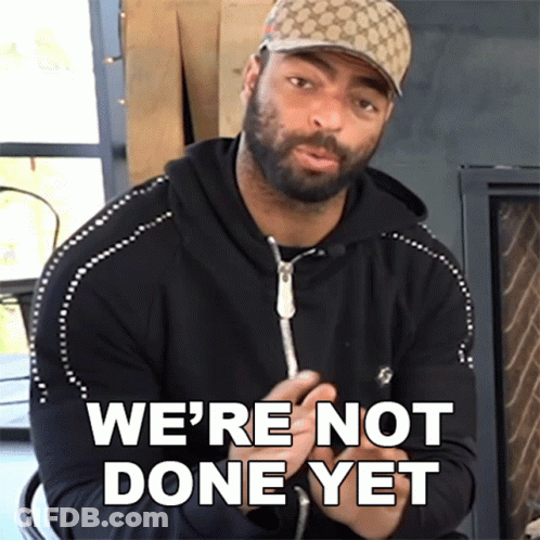 A Man Wearing A Hat Says " We 'Re Not Done Yet " In Front Of A Fireplace GIF
