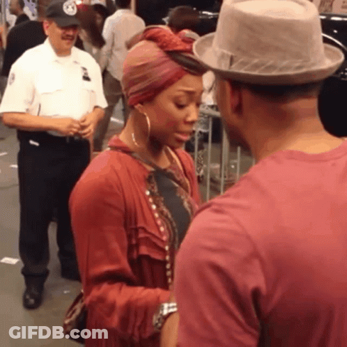 Man In Hat Talking To Woman With Turban GIF