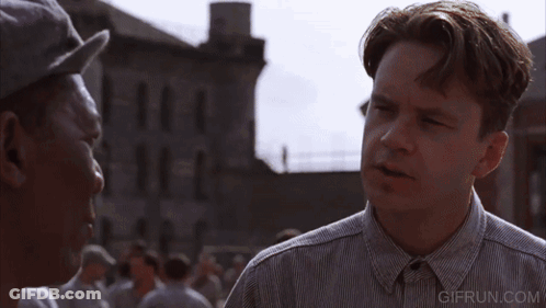 A Man Wearing A Hat Talks To Another Man With A Gifrun.com Watermark GIF