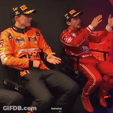 A Man Wearing A Hat That Says 1St Is Sitting Next To Another Man GIF
