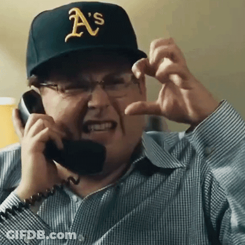 A Man Wearing A Hat That Says A 'S Is Talking On A Phone GIF
