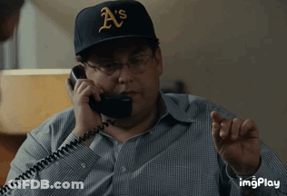 A Man Wearing A Hat That Says A 'S Is Talking On A Phone GIF