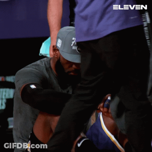 A Man Wearing A Hat That Says Finals Is Kneeling Down GIF