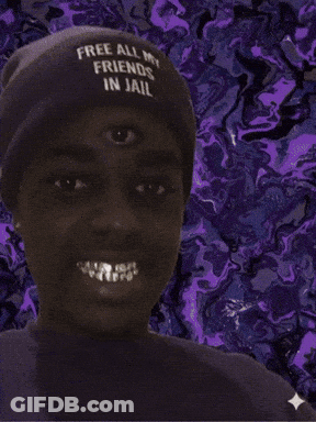 A Man Wearing A Hat That Says Free All My Friends In Jail Smiles GIF