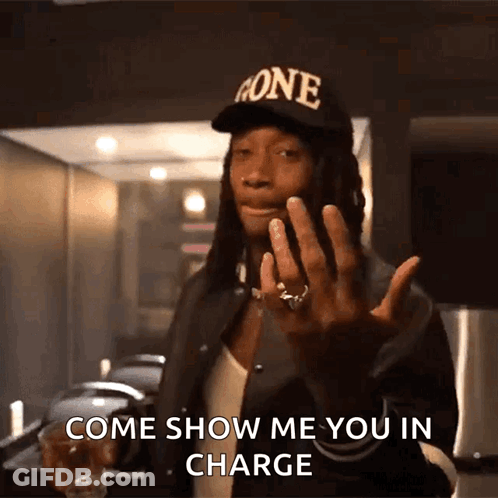 A Man Wearing A Hat That Says Gone Is Holding A Shot Glass And Says Come Show Me You In Charge GIF