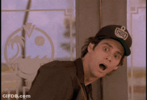 A Man Wearing A Hat That Says Hudson Is Standing In Front Of A Window GIF
