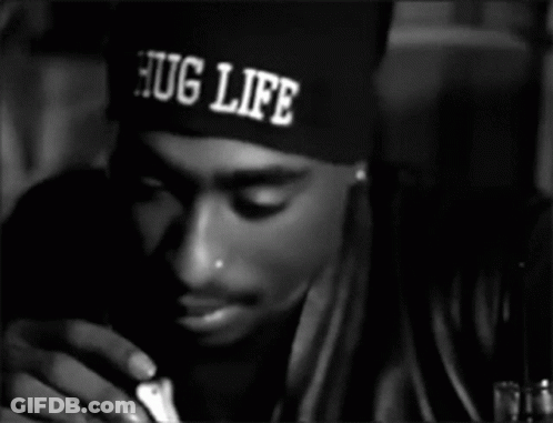 A Man Wearing A Hat That Says Hug Life On It GIF
