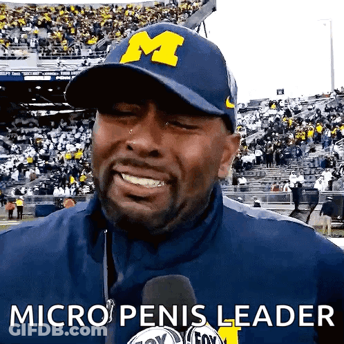 A Man Wearing A Hat That Says M On It GIF