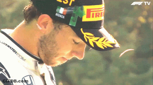 A Man Wearing A Hat That Says Monza GIF