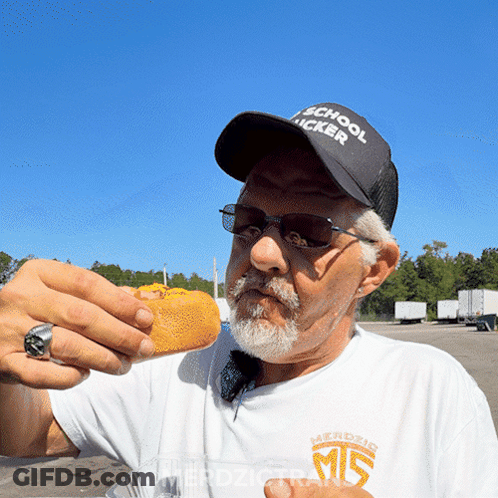 A Man Wearing A Hat That Says " School Trucker " GIF
