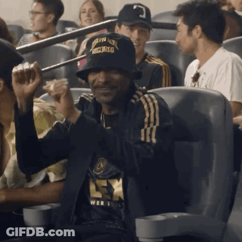 A Man Wearing A Hat That Says " Snoop Dogg " On It GIF