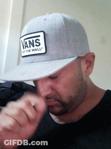 A Man Wearing A Hat That Says Vans Off The Wall GIF
