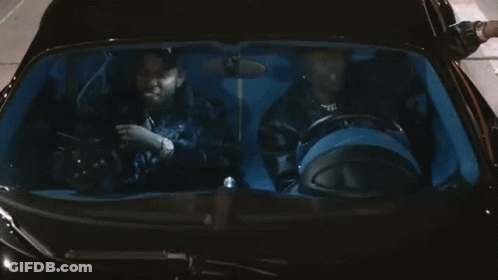 A Man Wearing A Hat That Says Xbok Is Sitting In A Car GIF