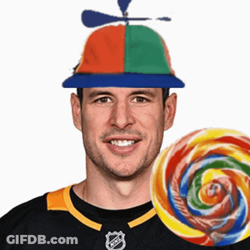 A Man Wearing A Hat With A Propeller And A Lollipop In Front Of Him GIF
