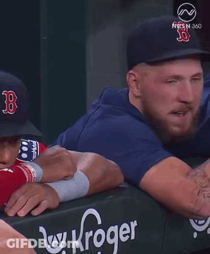 A Man Wearing A Hat With The Letter B On It Talks To Another Man GIF