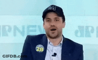 A Man Wearing A Hat With The Letter M On It Is Pointing GIF