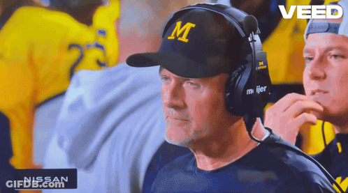 A Man Wearing A Hat With The Letter M On It Watches A Game GIF