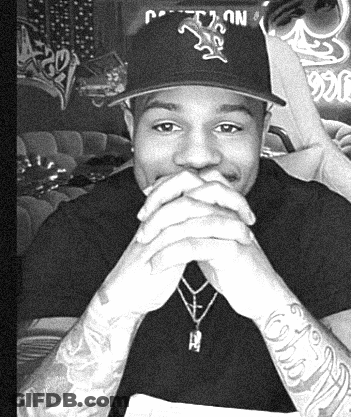 A Man Wearing A Hat With The Letter T On It GIF