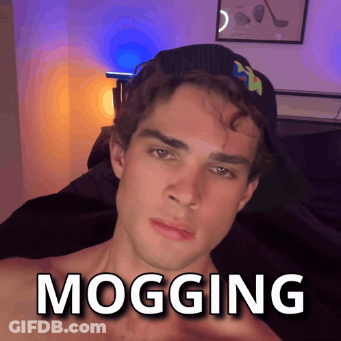 A Man Wearing A Hat With The Word Mogging Written On It GIF