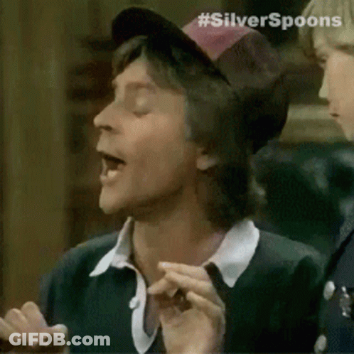 A Man Wearing A Hat With The Word Silver Spoons On It . GIF