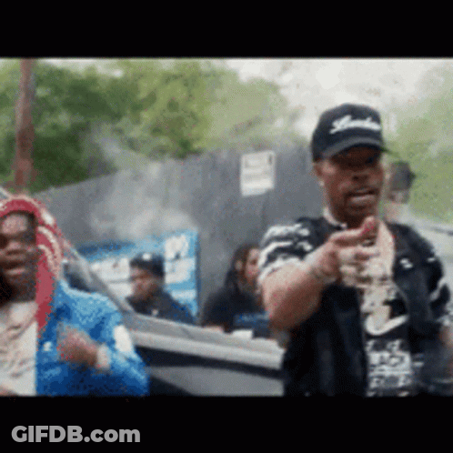 A Man Wearing A Hat With The Word Yankees On It Is Pointing GIF
