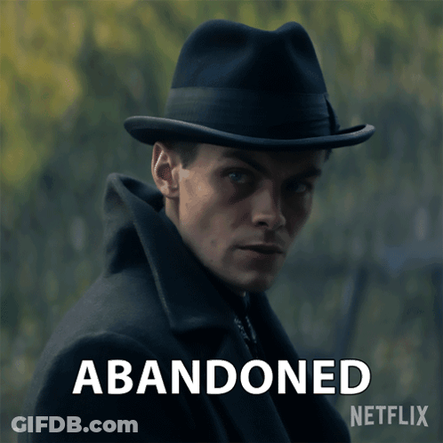 A Man Wearing A Hat With The Words Abandoned Written Below Him GIF