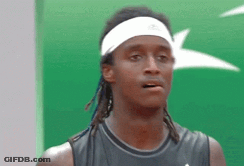 A Man Wearing A Headband And A Black Tank Top Looks At The Camera GIF
