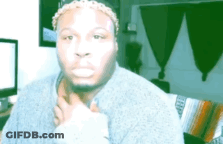 A Man Wearing A Headband And A Sweater Is Making A Funny Face While Sitting On A Couch . GIF