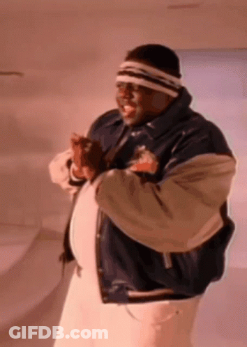 Man With Headband And Varsity Jacket Standing In Room GIF