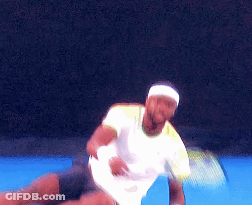A Man Wearing A Headband And A White Shirt Is Playing Tennis GIF