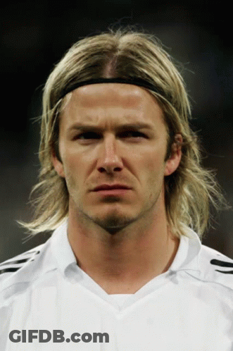 A Man Wearing A Headband And A White Shirt Looks At The Camera GIF