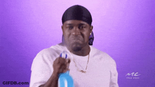 A Man Wearing A Headband And A White Shirt With The Word Mc On It GIF